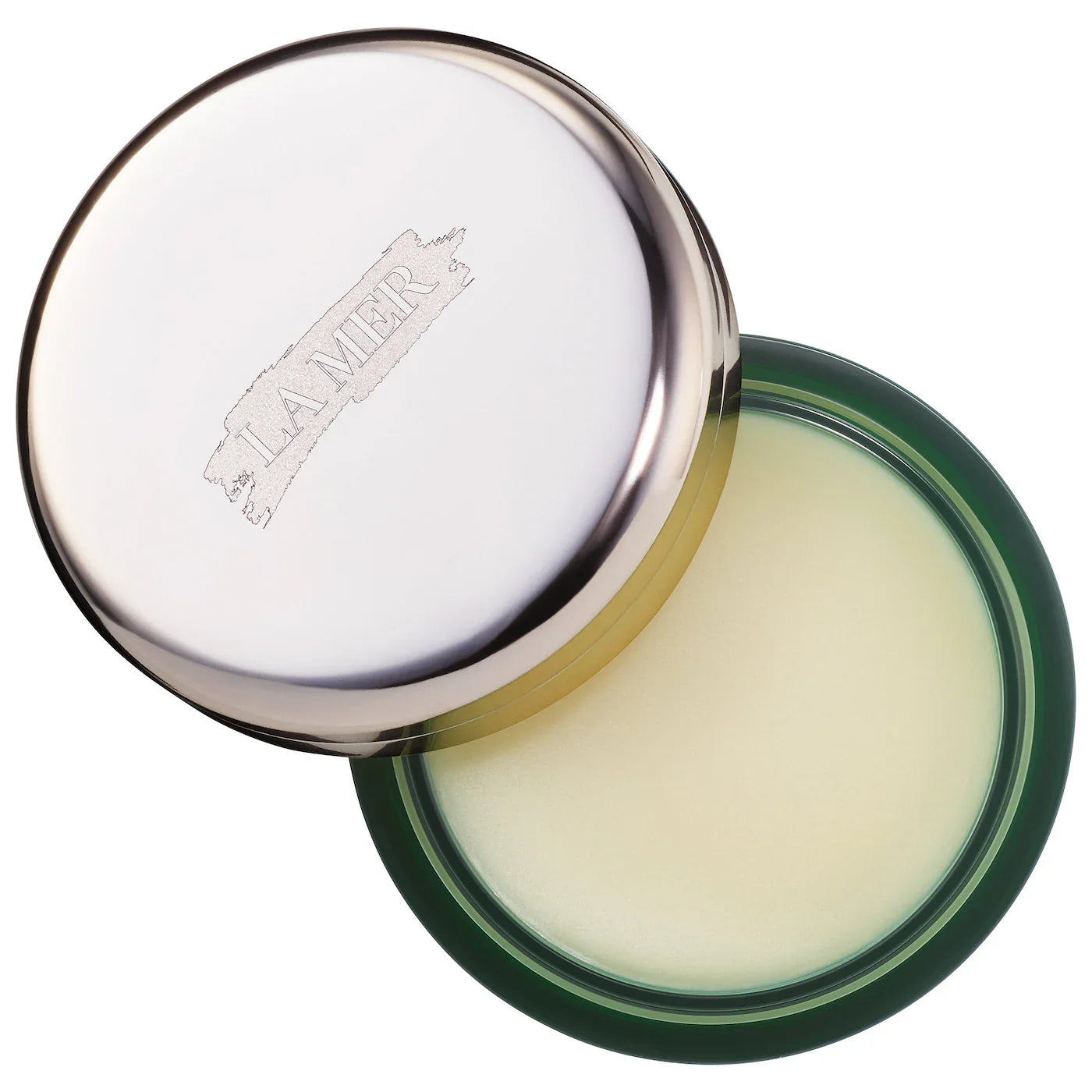 Luxury La Mer lip balm in signature green and silver packaging.
