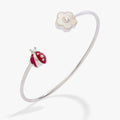 Silver flex cuff featuring a Mother of Pearl daisy and a red enamel ladybug