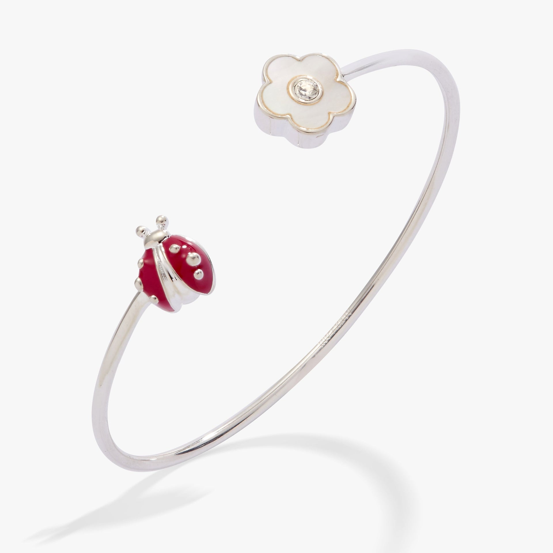 Silver flex cuff featuring a Mother of Pearl daisy and a red enamel ladybug