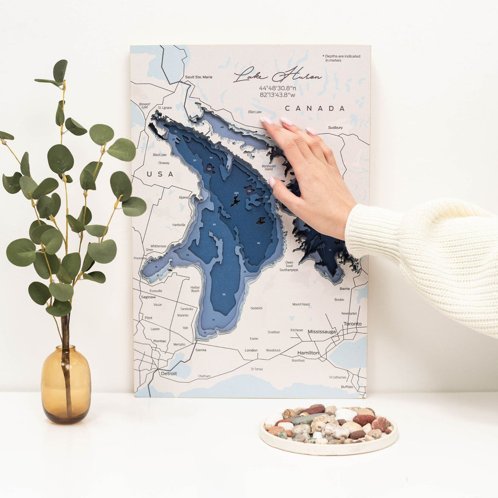 Detailed wooden Lake Huron wall art map in blue and off-white coastal decor style