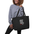 An extra-large organic cotton tote bag with the text 'Stitch Bitch Resist Repeat' printed on the front.