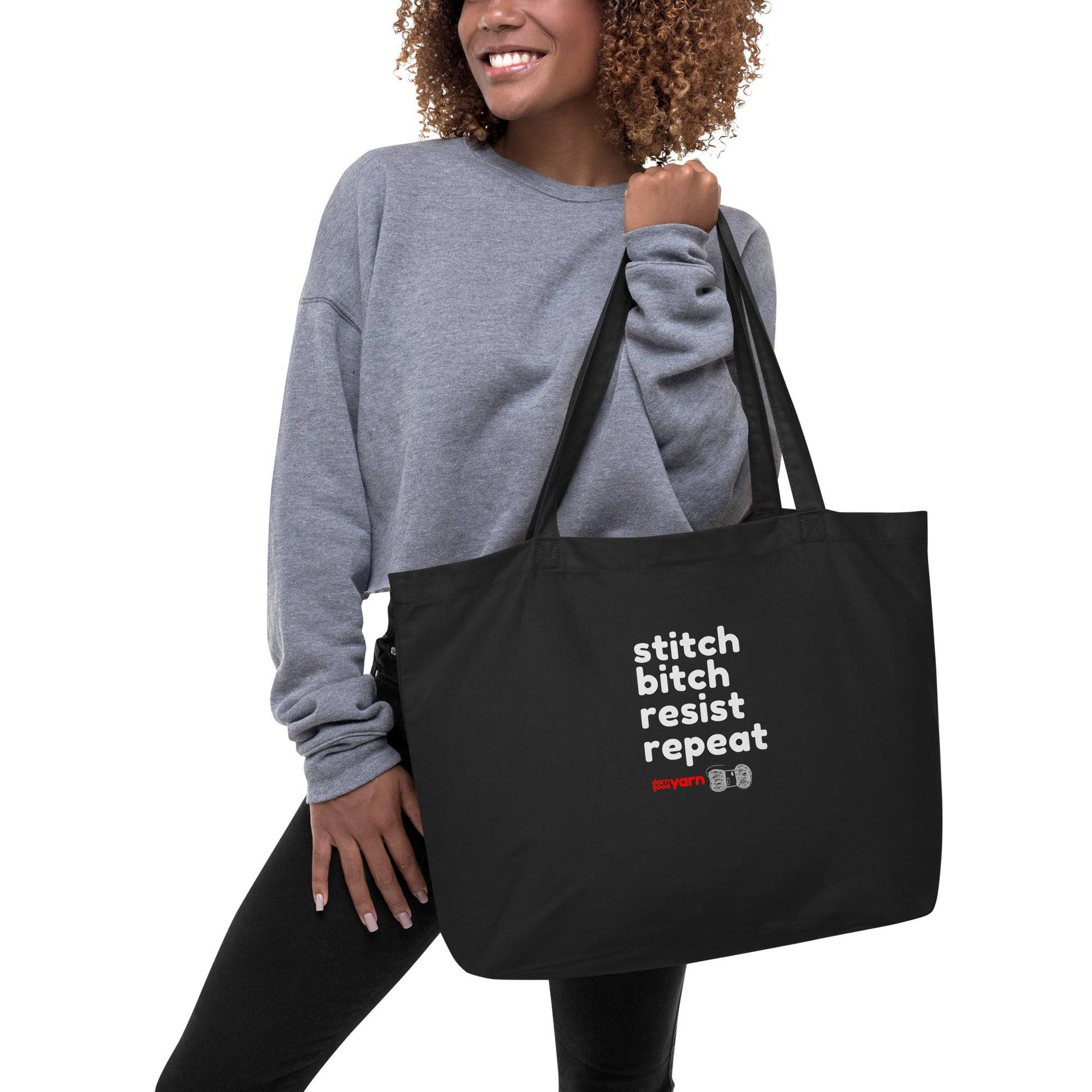 An extra-large organic cotton tote bag with the text 'Stitch Bitch Resist Repeat' printed on the front.