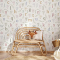 Whimsical Lenny wallpaper in off-white and muted-multicolor patterns for a nursery
