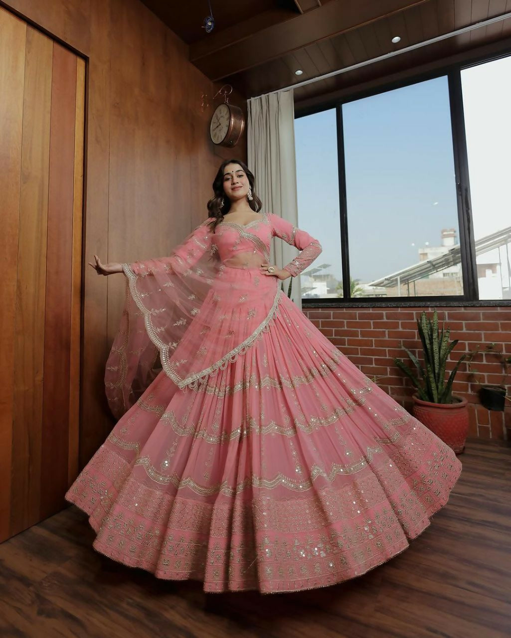 A designer baby pink lehenga choli set with 5MM sequins and zari embroidery in faux georgette fabric.