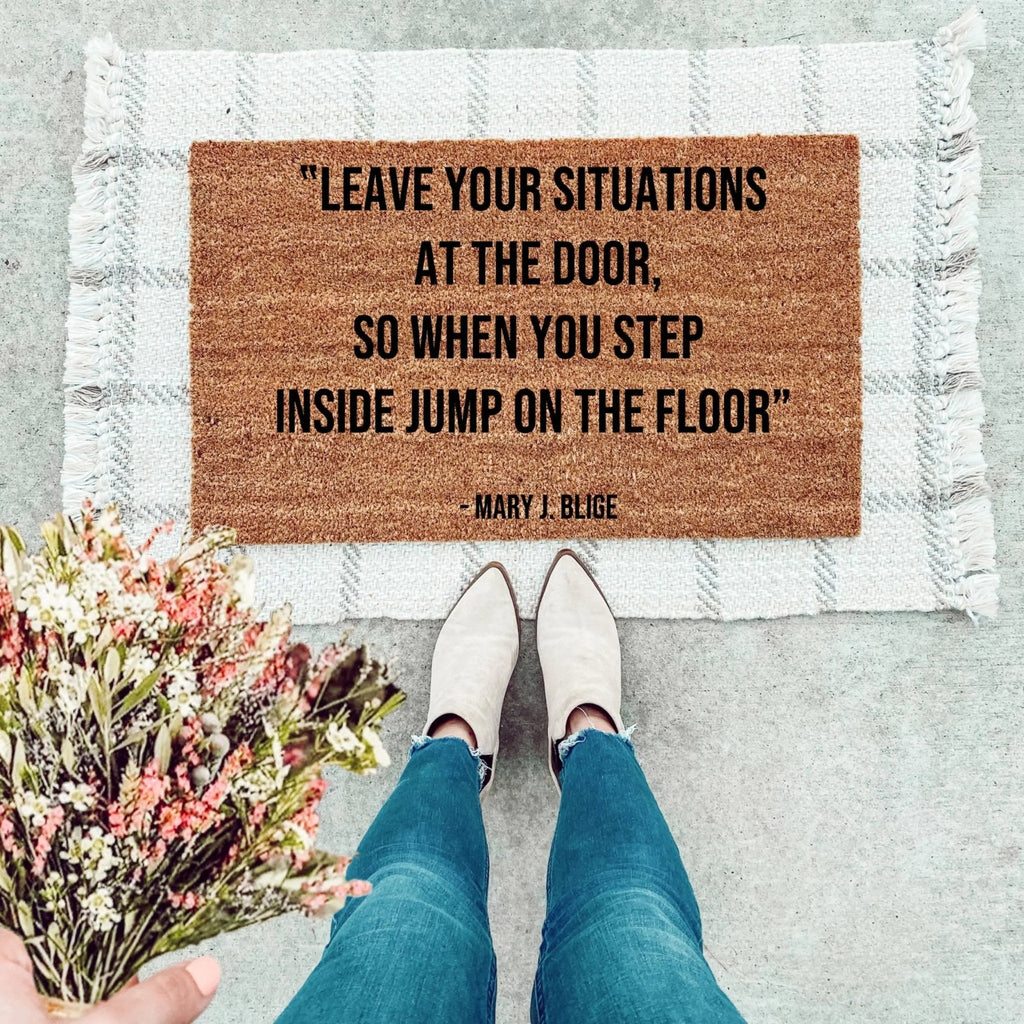 Natural brown and black coir doormat featuring the text Leave Your Situations At The Door.