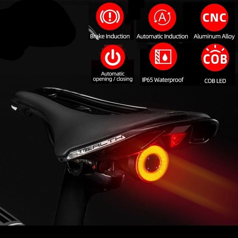 Smart LED bicycle taillight in matte black with red lens mounted on a bike seat post