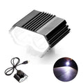 A matte black industrial LED bicycle headlight with silver reflectors and a compact, modern design.