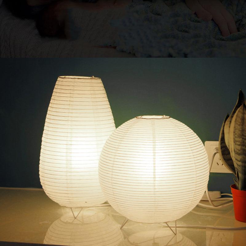 Minimalist white paper lantern table lamp on a bedroom side table