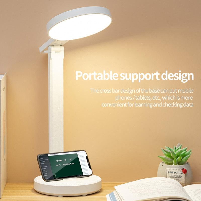 Minimalist white LED desk lamp with integrated wireless charger and clock stand