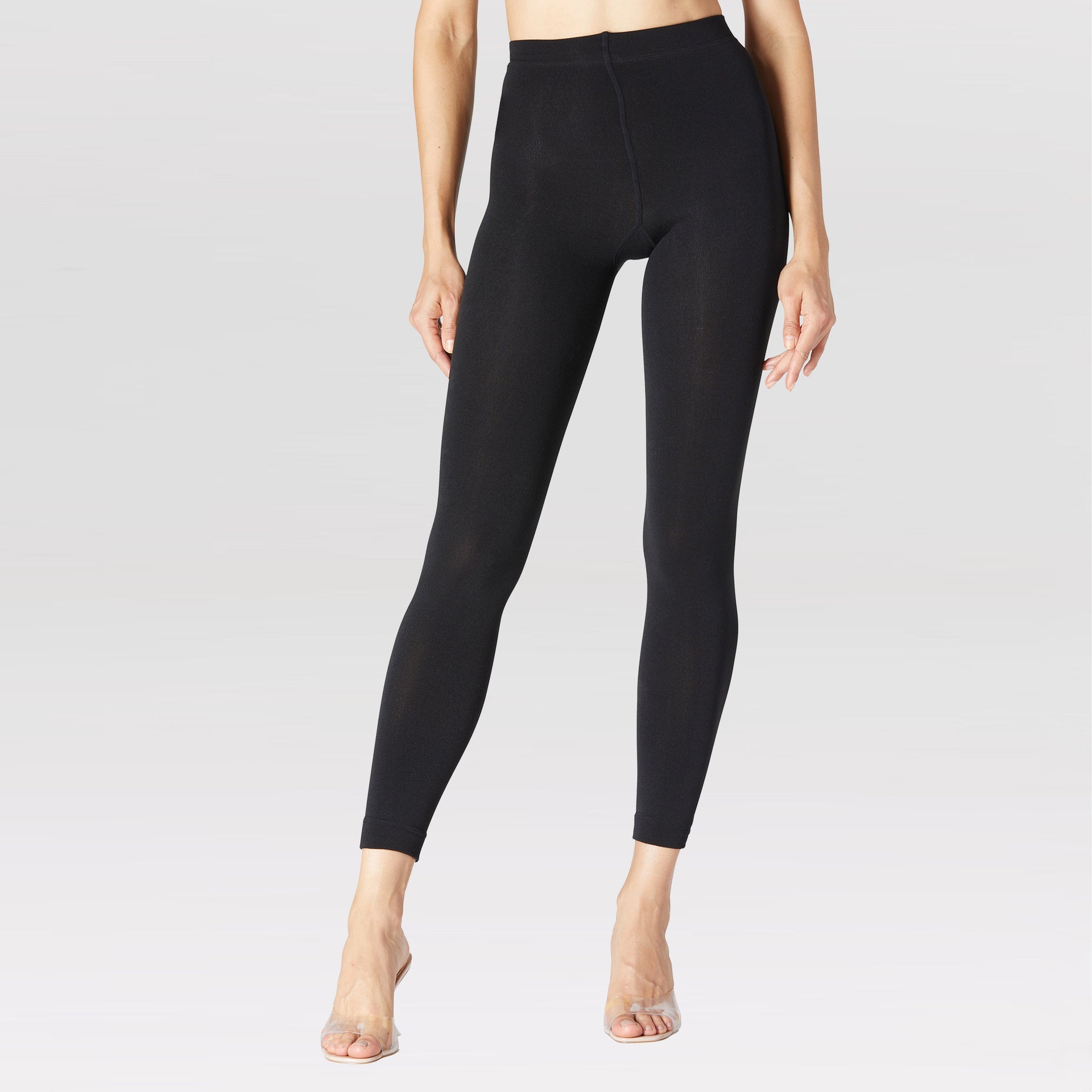 Model wearing black slim fleece-lined base layer leggings with 300 denier thickness