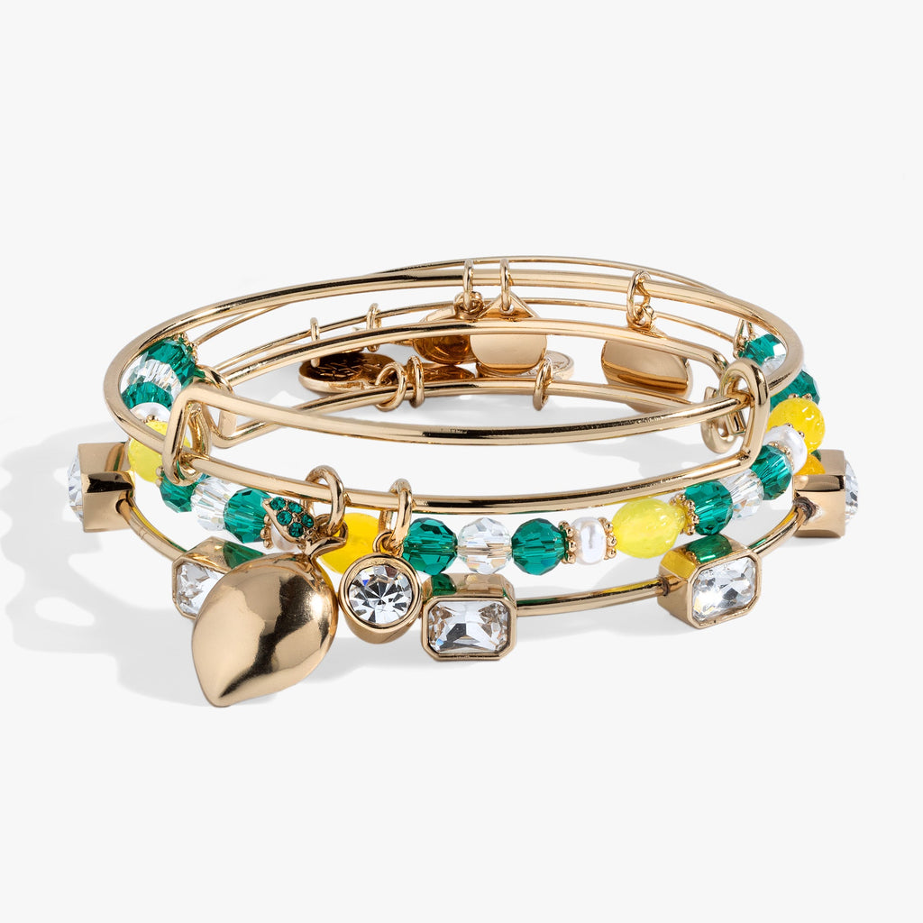 Set of three lemon-themed charm bangles featuring crystal-studded lemons and floral designs