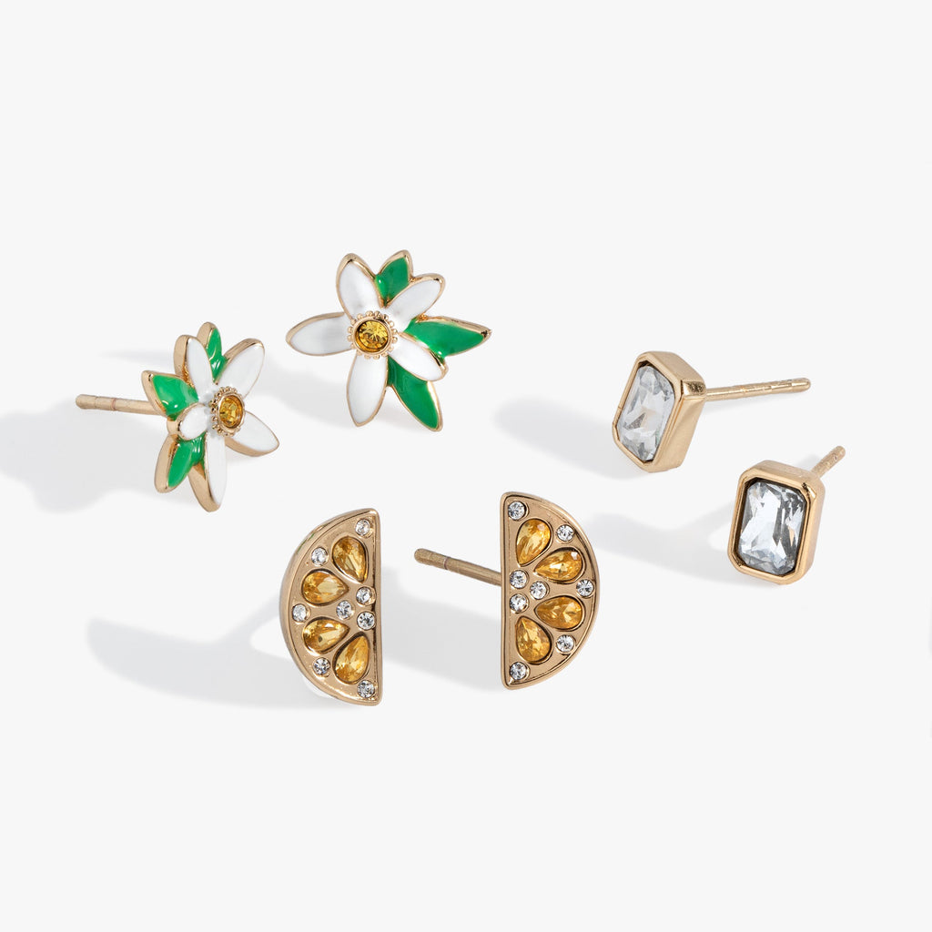 Set of three gold-tone lemon-themed earrings featuring a crystal lemon wedge, lemon blossom, and an emerald-cut crystal stud.