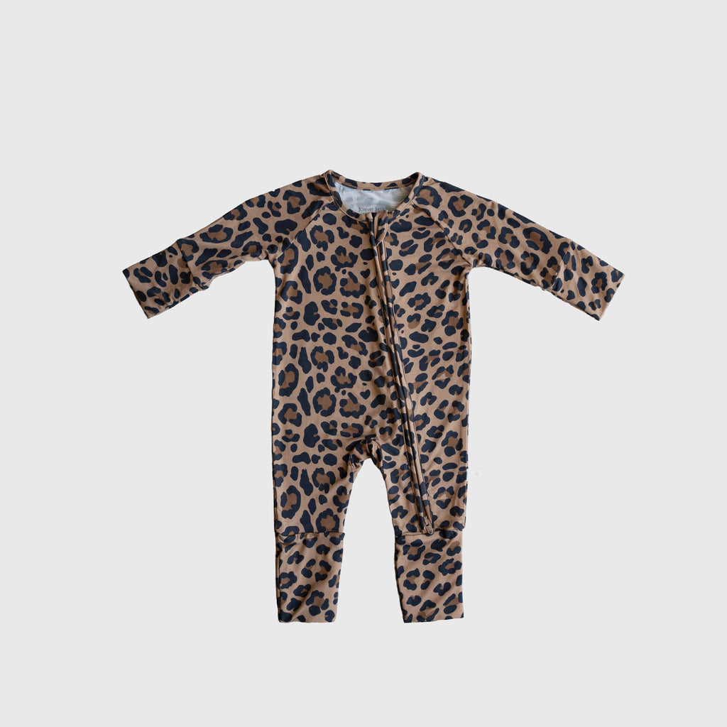 Baby wearing soft leopard print bamboo zip pajamas with convertible foot cuffs