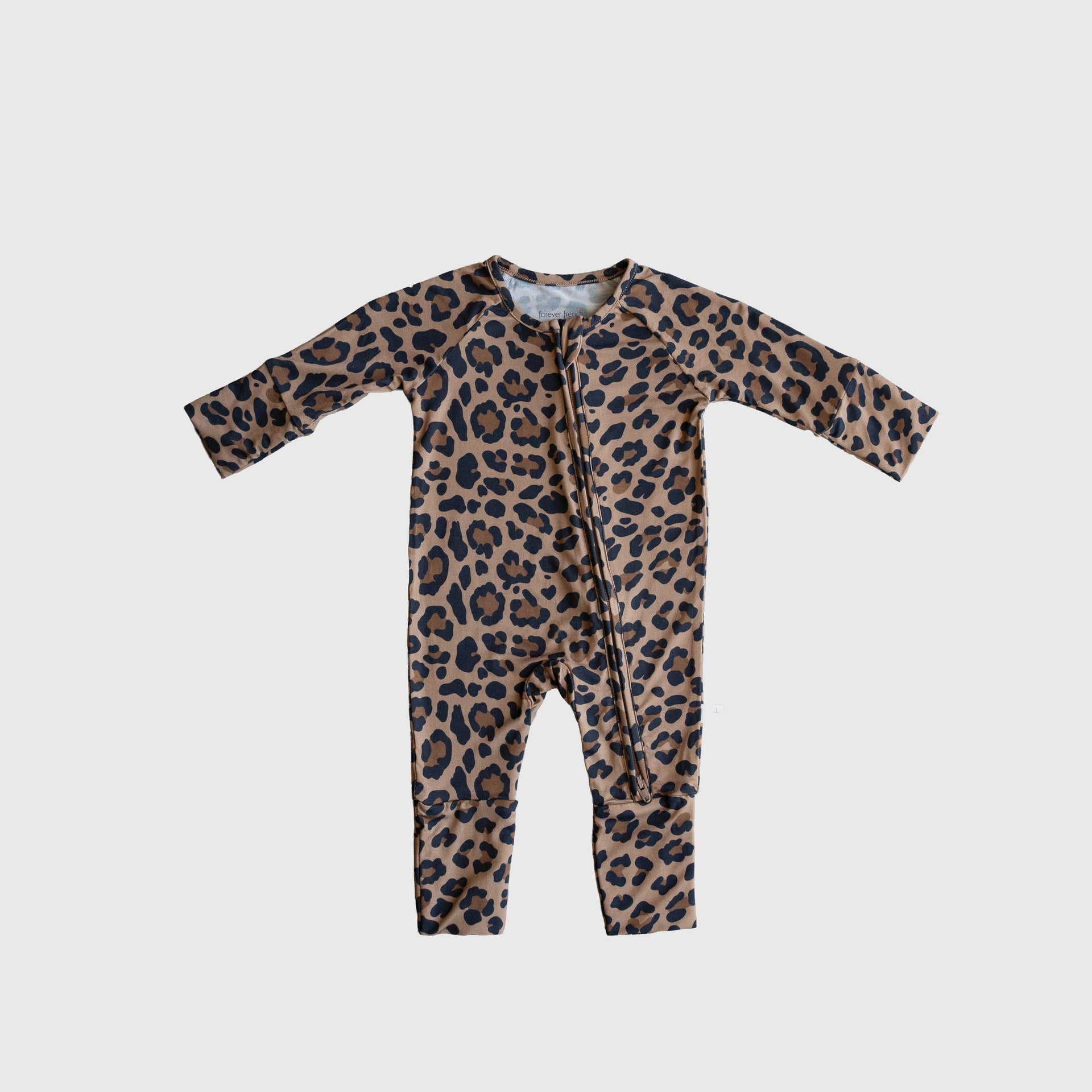 Baby wearing soft leopard print bamboo zip pajamas with convertible foot cuffs