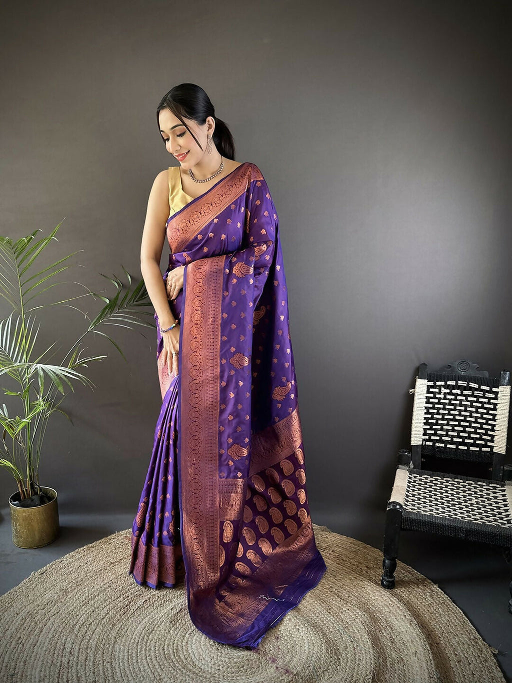 Purple Banarasi woven soft silk saree showcasing rich woven patterns and matching fabric.