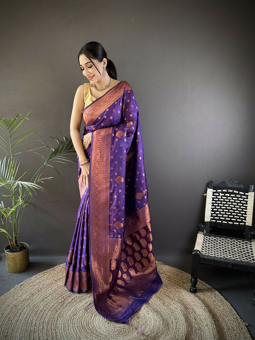 Purple Banarasi woven soft silk saree showcasing rich woven patterns and matching fabric.