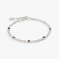 Close up of a light amethyst gemstone set in a classic polished curb chain bracelet