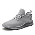 A pair of neutral-toned men's breathable mesh running sneakers with a minimalist, sporty design.