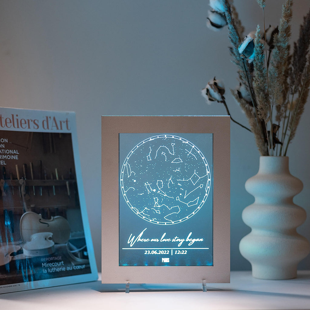 Modern 8x10 metallic silver Star Light Frame with celestial LED projection on a bedroom side table.