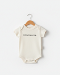 Cream cotton baby onesie with 'Little Blessing' script print