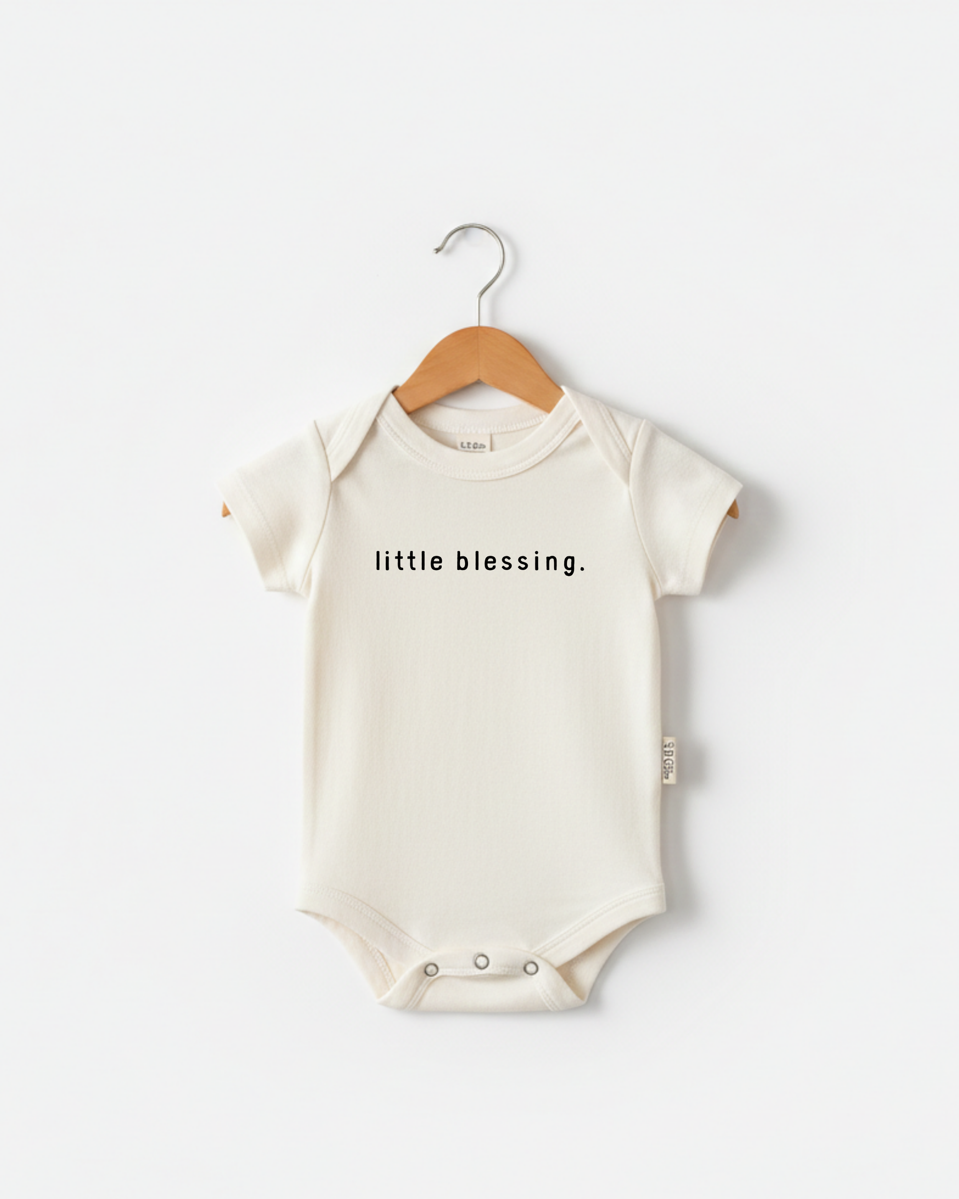 Cream cotton baby onesie with 'Little Blessing' script print