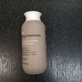 Beige and white bottle of Living Proof No Frizz Wave Shaping, Curl Defining for Thick to Coarse Hair 4 fl oz