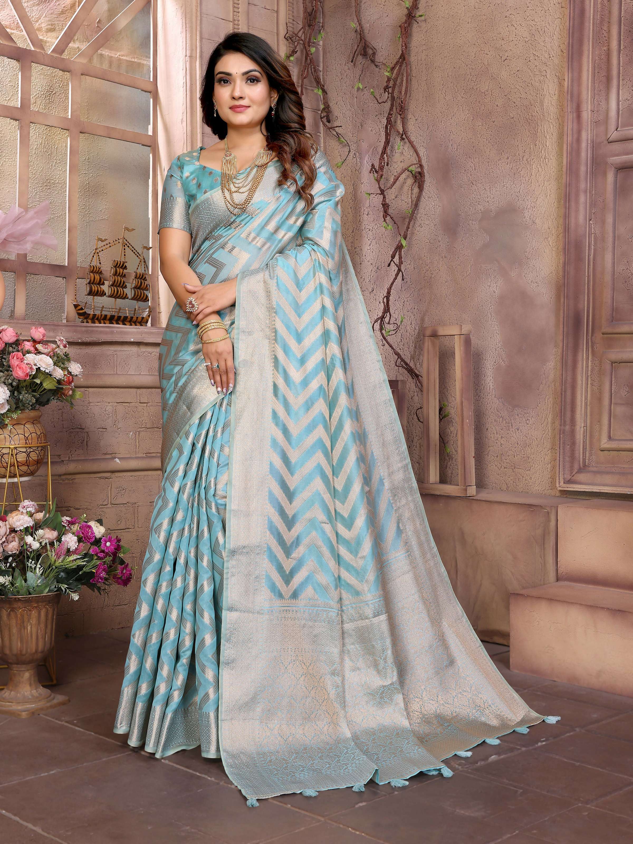 A soft Sky blue Organza Silk saree featuring intricate weaving, displayed for an elegant festive look.