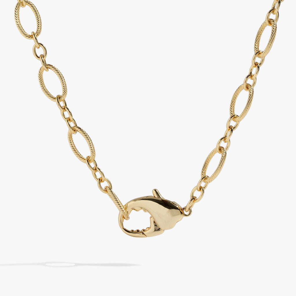 Chunky gold-tone lobster claw design convertible necklace and layered wrap bracelet on a white background.