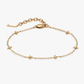 Minimalist star-station chain bracelet in gold and silver tones, highlighting diamond-cut cable links.