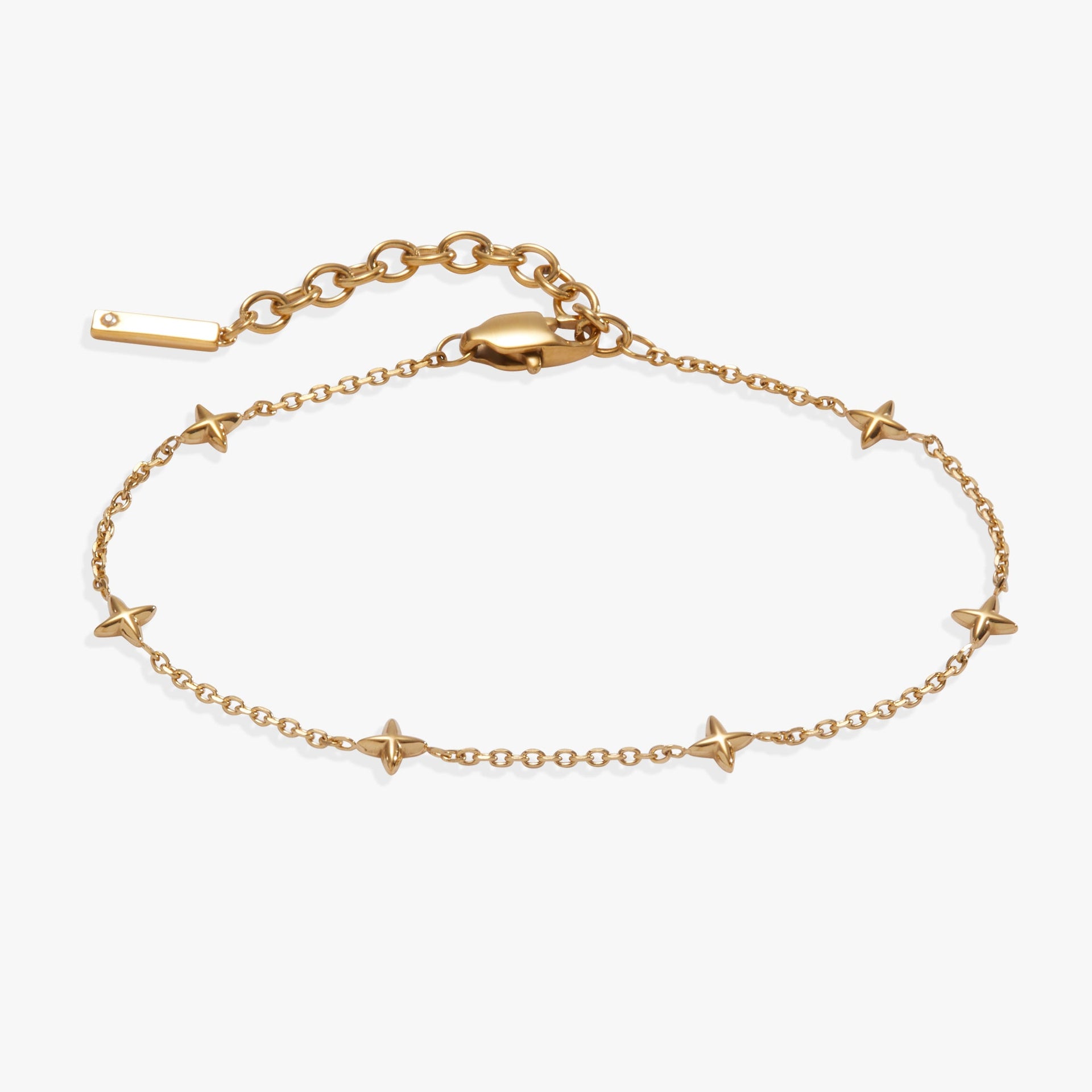 Minimalist star-station chain bracelet in gold and silver tones, highlighting diamond-cut cable links.
