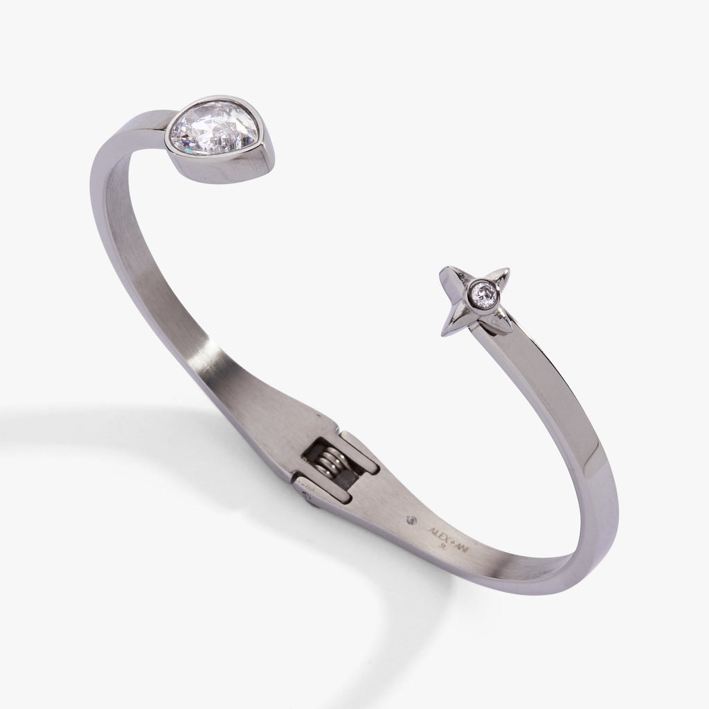 Crystal teardrop and star hinged bypass cuff bracelet featuring a sparkling pear-shaped stone.