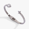 Crystal teardrop and star hinged bypass cuff bracelet featuring a sparkling pear-shaped stone.
