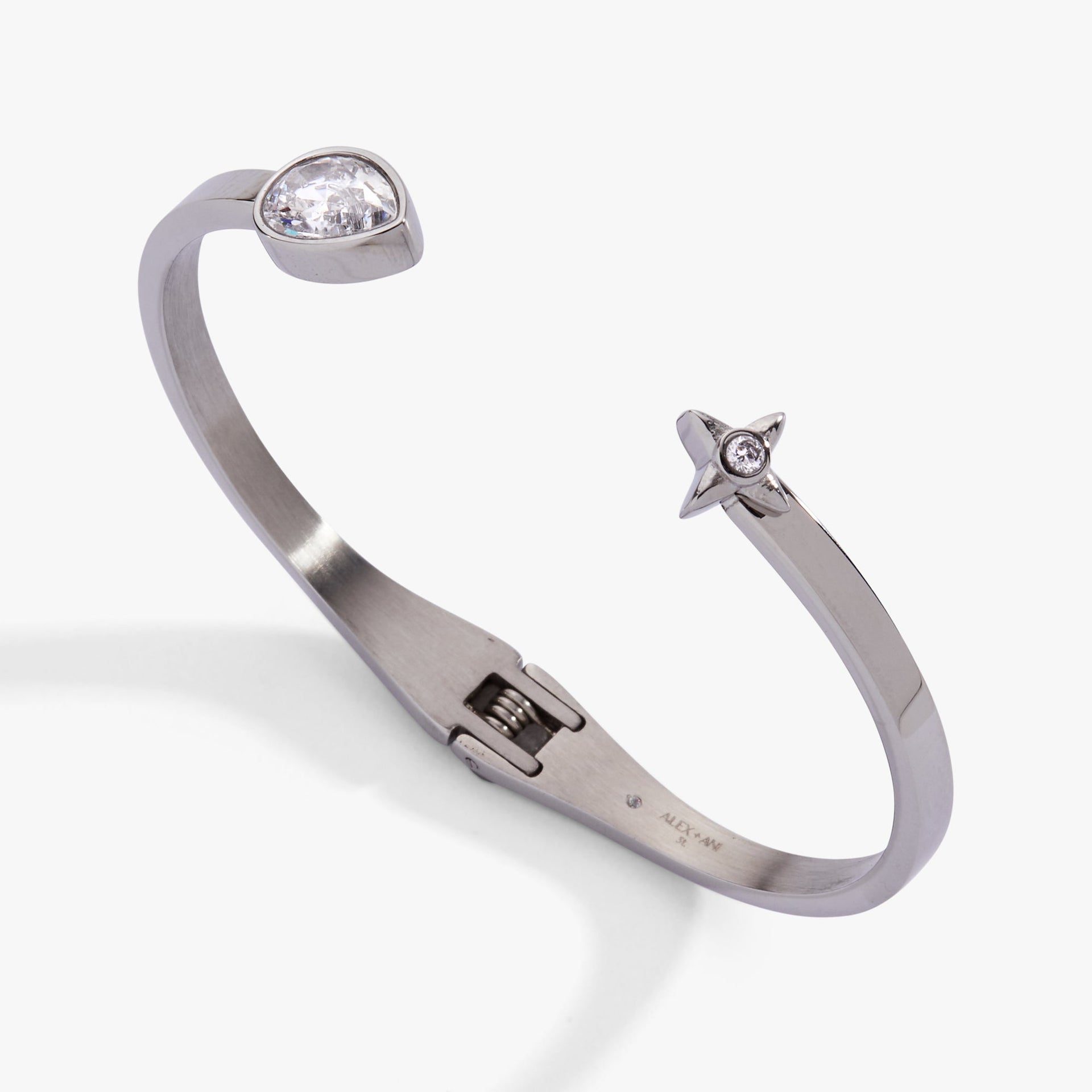 Crystal teardrop and star hinged bypass cuff bracelet featuring a sparkling pear-shaped stone.