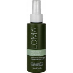 Loma Nourishing Oil Treatment in a deep forest green pump bottle