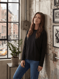 Model wearing a black long sleeve boxy crewneck t-shirt with jeans