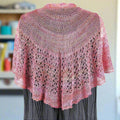 Close-up of the intricate Lotus Lace shawl knitting pattern featuring hand-beaded silk yarn.