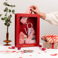 Elegant red wooden travel keepsake box on a modern desk surface