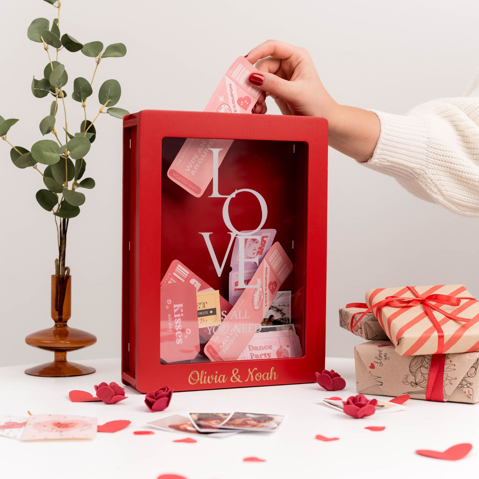 Elegant red wooden travel keepsake box on a modern desk surface