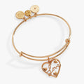Gold tone bangle featuring a heart charm with Love script text