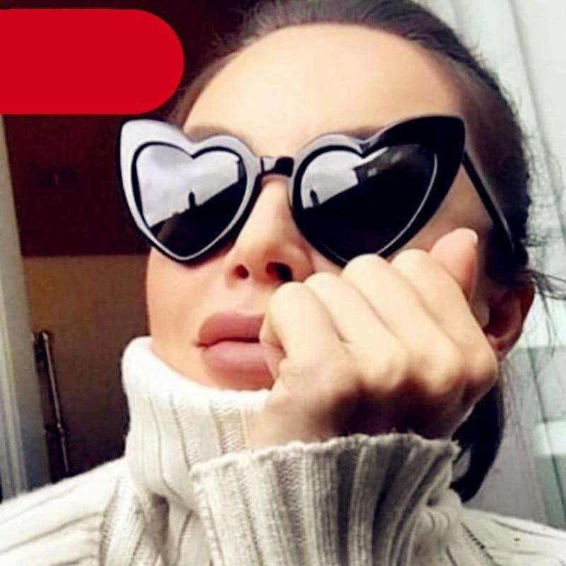 Pair of retro heart-shaped sunglasses in red with a metallic frame