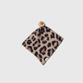 Soft leopard print knit lovey for babies in warm earth tones, displayed in a modern nursery setting.