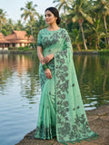 Woman wearing a solid Rama Green linen cotton saree with matching blouse