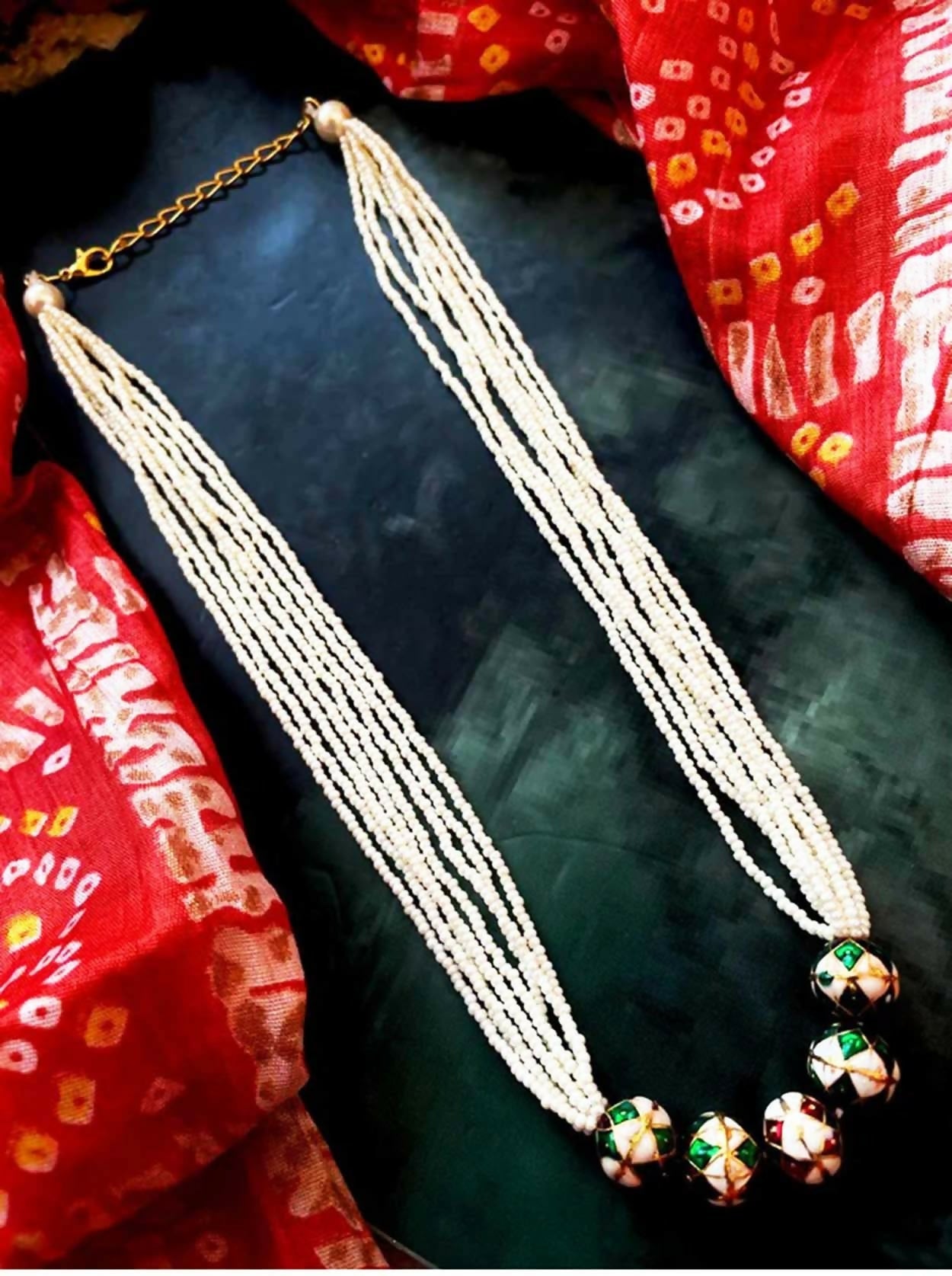 Close-up of a vibrant multicolor Meenakari ball necklace set in polished brass