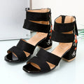 Pair of women's black sandals with floral embroidery on the thick block heel and open-toe design