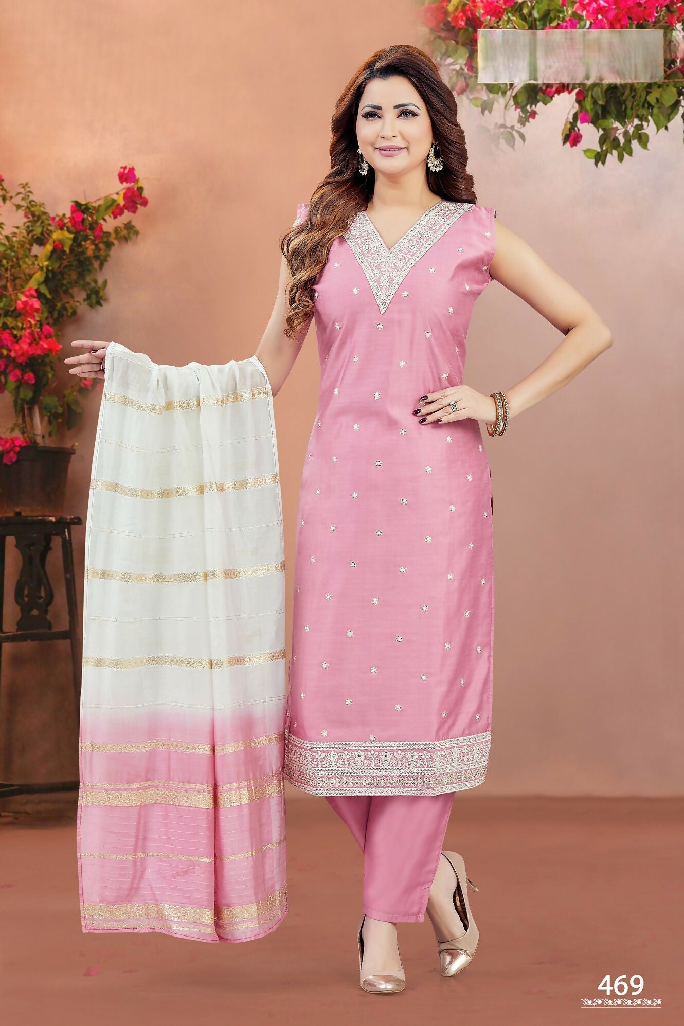 Woman wearing a baby pink Chanderi silk V-neck kurta set with intricate embroidery detailing.