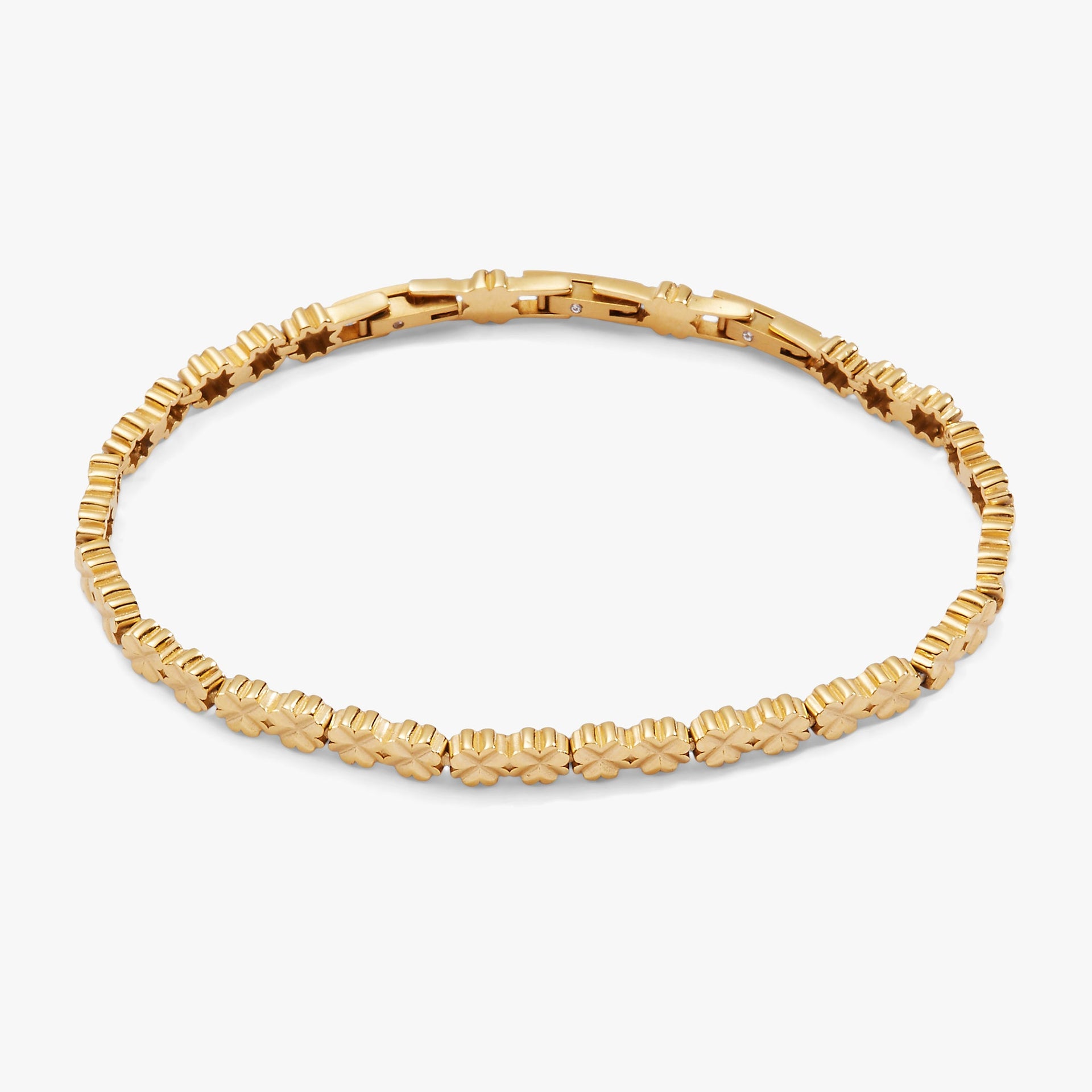 Gold-tone stainless steel tennis bracelet featuring inline four-leaf clover charms.