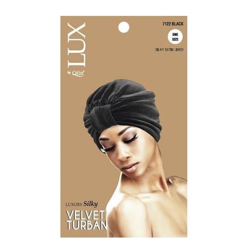 A woman wearing a LUX by Qfitt plush velvet turban in black with a silky satin lining.
