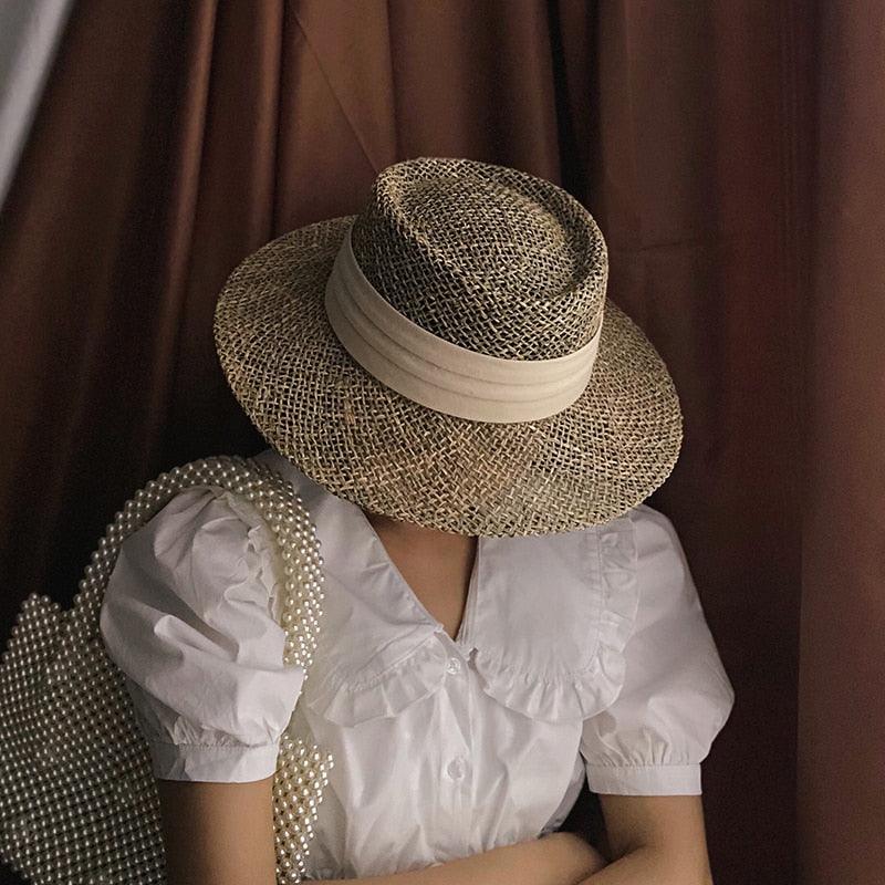 Luxurious handmade straw beach hat with flat brim and unique design for women