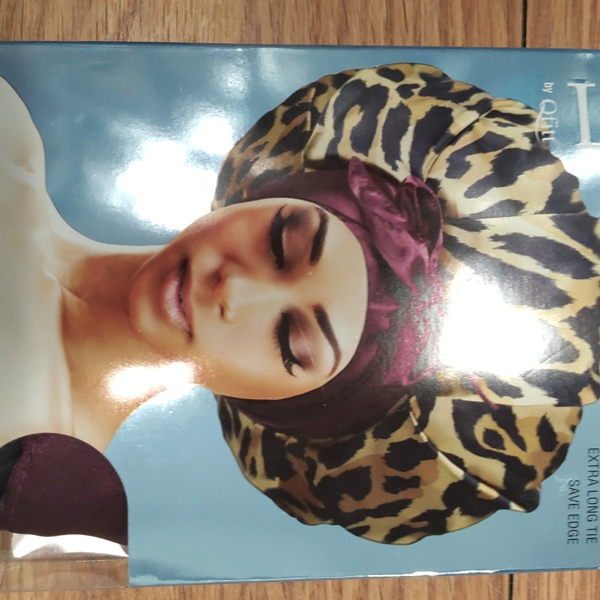 Woman wearing a luxurious satin tie bonnet in leopard print for hair protection.