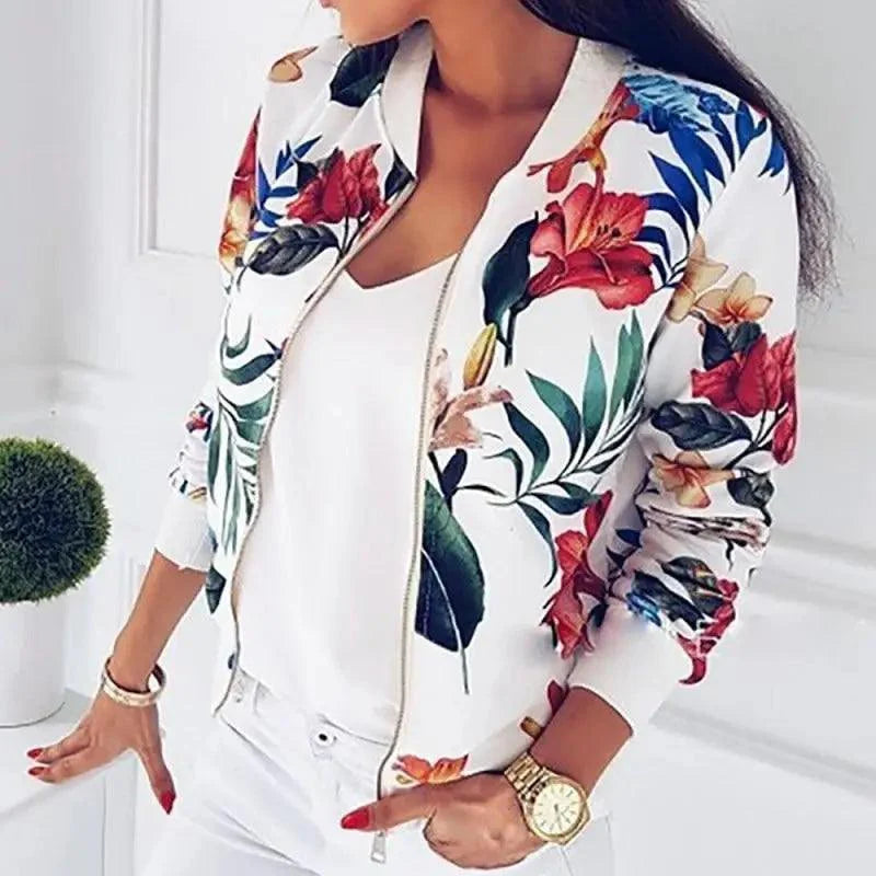 Close-up of a women's floral print long sleeve bomber jacket with a front zipper and side pockets
